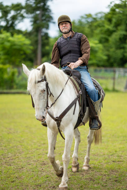 istock A senior gentleman riding a horse in paddock field 1403364877