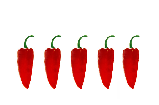Red capia peppers isolated on a white background in a row
