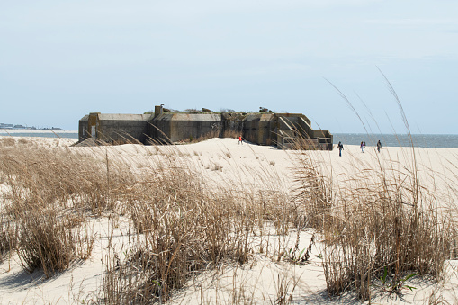 Tourists at World War II Gun Battery 223 on beach in Cape May Point State Park, Cape May, New Jersey, USA