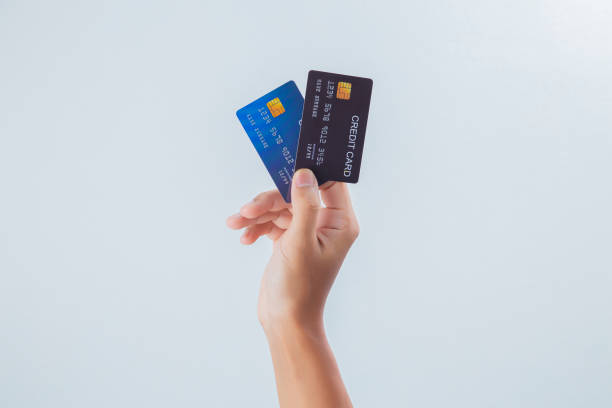 istock Hand holding credit card isolated on white 1403380175