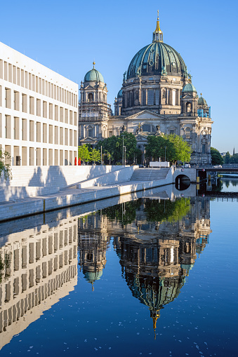 The Berliner Dom with the rebuilt City Palace reflected in the river Spree