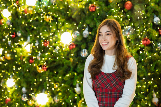 istock woman with Christmas tree, x-mas celebrating 1403381426