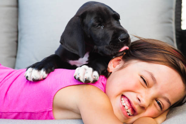 Little girl holding her puppy.