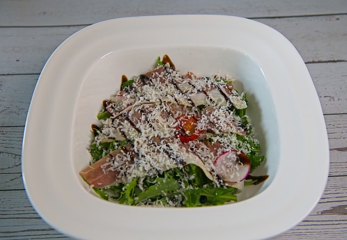 Rucola salad with sliced Parma ham and cherry tomatoes