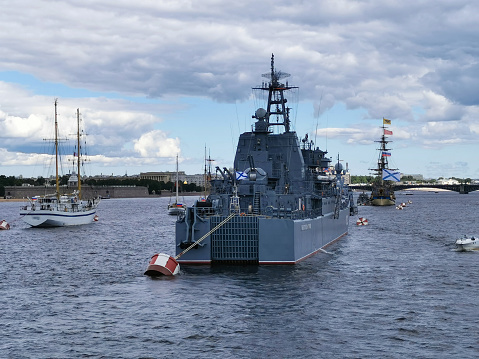 View from the bridge of a warship and sailboats in the Neva water area for the Day of the Navy in St. Petersburg.