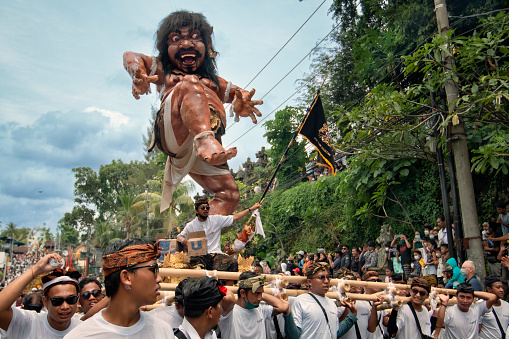 procession of the Ogoh-ogoh Paper Statue in Denpasar Bali at the Ngaben Cremation ceremony according to Hinduism