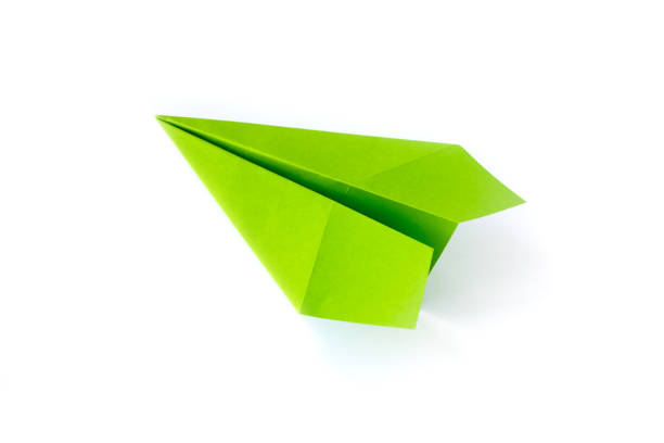 istock Green paper plane origami isolated on a white background 1403396559
