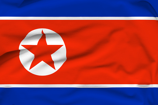 North Korea national flag, folds and hard shadows on the canvas.