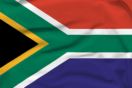 South Africa national flag, folds and hard shadows on the canvas.