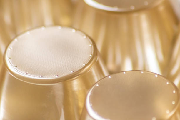 Abstract golden background pattern macro close-up of silver and golden metal surface with shiny reflections and harmonic shapes with circles and cones elegant futuristic design graphics metallic waves