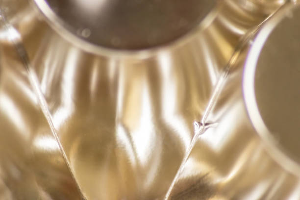istock Abstract golden background pattern macro close-up of silver and golden metal surface with shiny reflections and harmonic shapes with circles and cones elegant futuristic design graphics metallic waves 1403399385