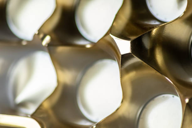 istock Abstract golden background pattern macro close-up of silver and golden metal surface with shiny reflections and harmonic shapes with circles and cones elegant futuristic design graphics metallic waves 1403399558