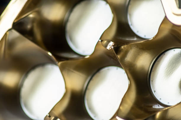Abstract golden background pattern macro close-up of silver and golden metal surface with shiny reflections and harmonic shapes with circles and cones elegant futuristic design graphics metallic waves
