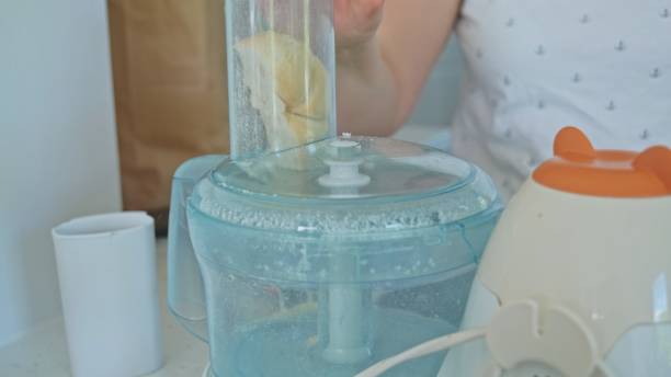 istock Caucasian Female Preparing Bread Crumbs Powder using Household Food Processor Kitchen Appliance 1403400794