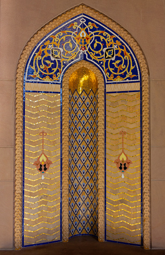 Traditional decoration in Arabian style,  ornament decoration background, Eastern ethnic golden oriental texture, Muscat, Oman. Sultan Qaboos Grand Mosque.