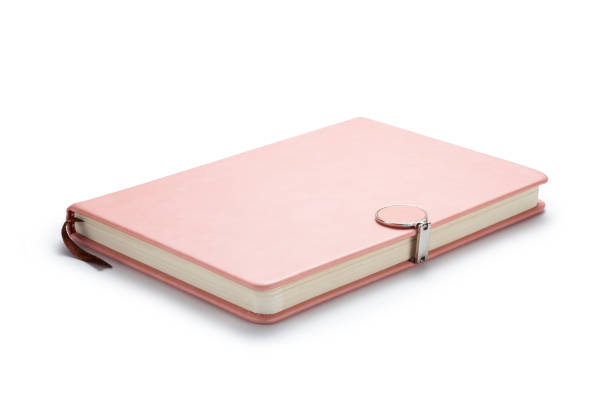 Pink notebook with a magnetic lock Pink notebook with a magnetic lock on white background. diary lock book cover book stock pictures, royalty-free photos & images