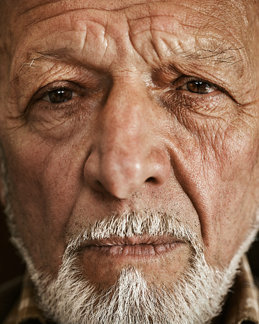 90 year old male contemplating. Black and white studio shot.