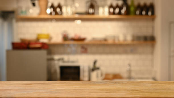 istock Wooden table and blurred modern kitchen in background. For display or montage your products. 1403408499