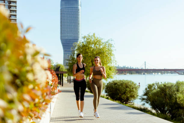 istock Young woman taking running exercise by the river promenade 1403409763