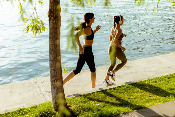 istock Young woman taking running exercise by the river promenade 1403409766