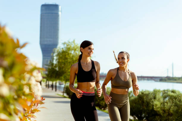 istock Young woman taking running exercise by the river promenade 1403409776