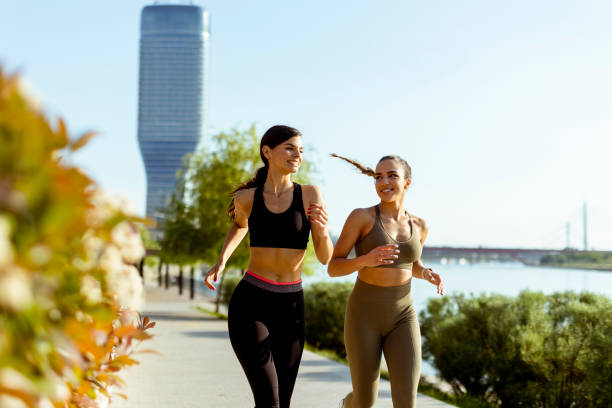 istock Young woman taking running exercise by the river promenade 1403409787