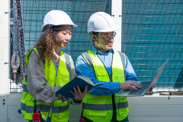 istock Engineer under checking the industry chilled water fan coil unit air conditioner is water cooling tower air chiller HVAC system of large industrial building to control air system 1403410989