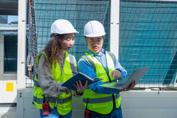 istock Engineer under checking the industry chilled water fan coil unit air conditioner is water cooling tower air chiller HVAC system of large industrial building to control air system 1403411001