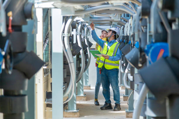 istock Engineer under checking the industry chilled water fan coil unit air conditioner is water cooling tower air chiller HVAC system of large industrial building to control air system 1403411024