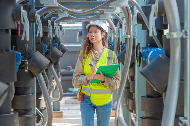 istock Engineer under checking the industry chilled water fan coil unit air conditioner is water cooling tower air chiller HVAC system of large industrial building to control air system 1403411035