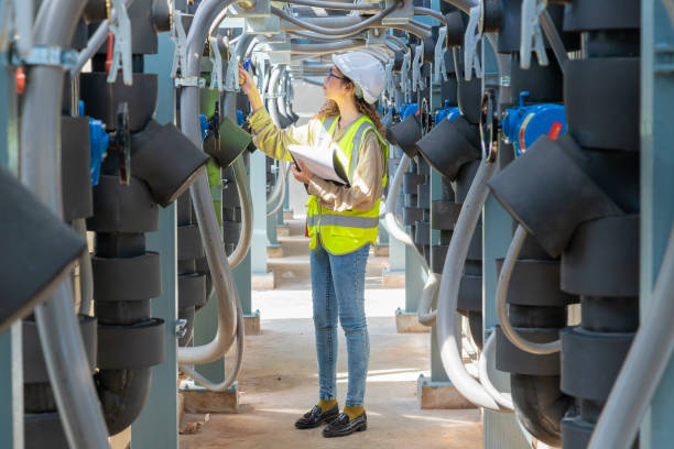 istock Engineer under checking the industry chilled water fan coil unit air conditioner is water cooling tower air chiller HVAC system of large industrial building to control air system 1403411360