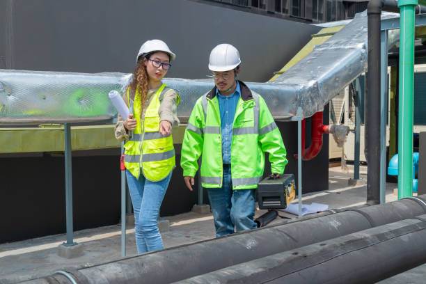 istock Engineer under checking the industry chilled water fan coil unit air conditioner is water cooling tower air chiller HVAC system of large industrial building to control air system 1403411383