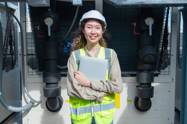 istock Engineer under checking the industry chilled water fan coil unit air conditioner is water cooling tower air chiller HVAC system of large industrial building to control air system 1403411483