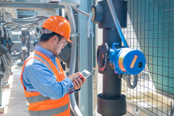 istock Engineer under checking the industry chilled water fan coil unit air conditioner is water cooling tower air chiller HVAC system of large industrial building to control air system 1403411545