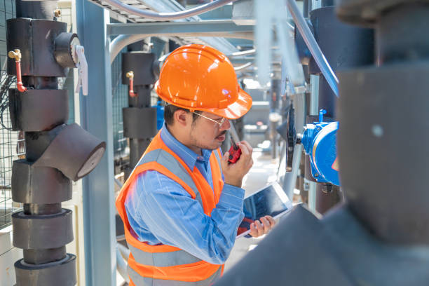 istock Engineer under checking the industry chilled water fan coil unit air conditioner is water cooling tower air chiller HVAC system of large industrial building to control air system 1403411547