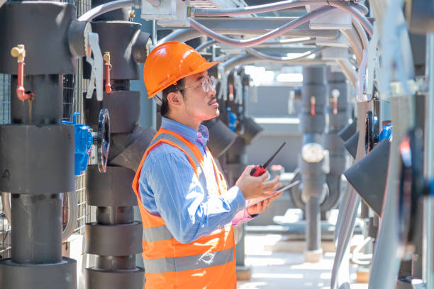 istock Engineer under checking the industry chilled water fan coil unit air conditioner is water cooling tower air chiller HVAC system of large industrial building to control air system 1403411596