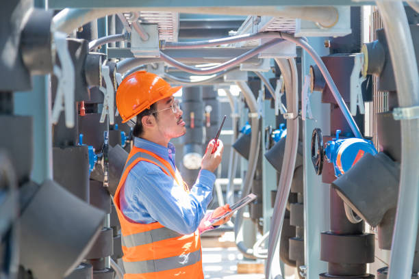istock Engineer under checking the industry chilled water fan coil unit air conditioner is water cooling tower air chiller HVAC system of large industrial building to control air system 1403411612