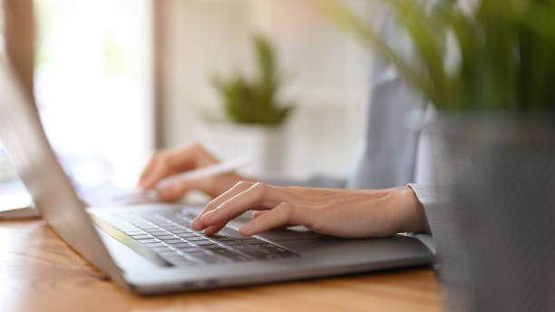 istock Cropped image, Businesswoman hand typing on portable laptop computer keyboard. 1403411654
