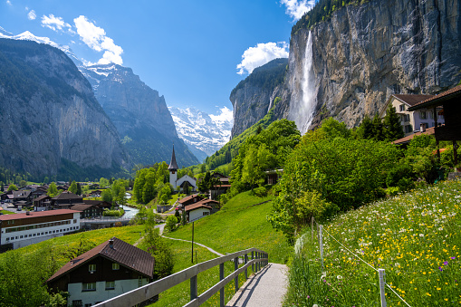 amazing alpine landscape in Lauterbrunnen village with church and waterfall in Switzerland