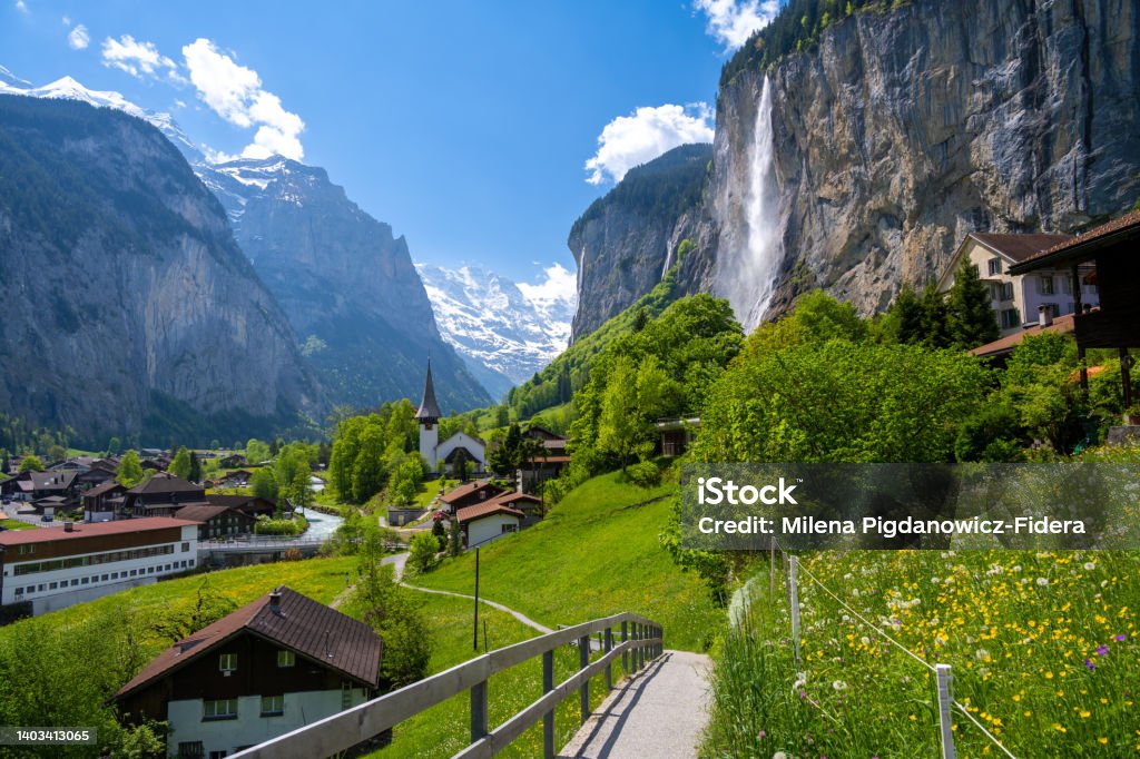 amazing alpine landscape in Lauterbrunnen village with church and waterfall in Switzerland Beautiful landscape of Switzerland in alpine village Switzerland Stock Photo