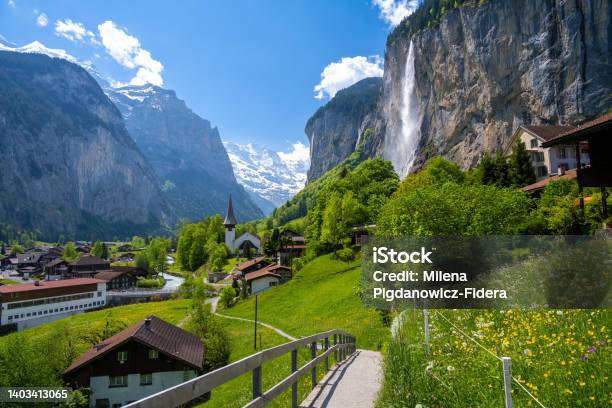 Amazing Alpine Landscape In Lauterbrunnen Village With Church And Waterfall In Switzerland Stock Photo - Download Image Now