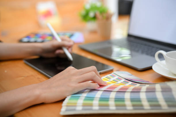 istock Cropped image, Female graphic designer using stylus pen, drawing on digital graphic tablet 1403413076