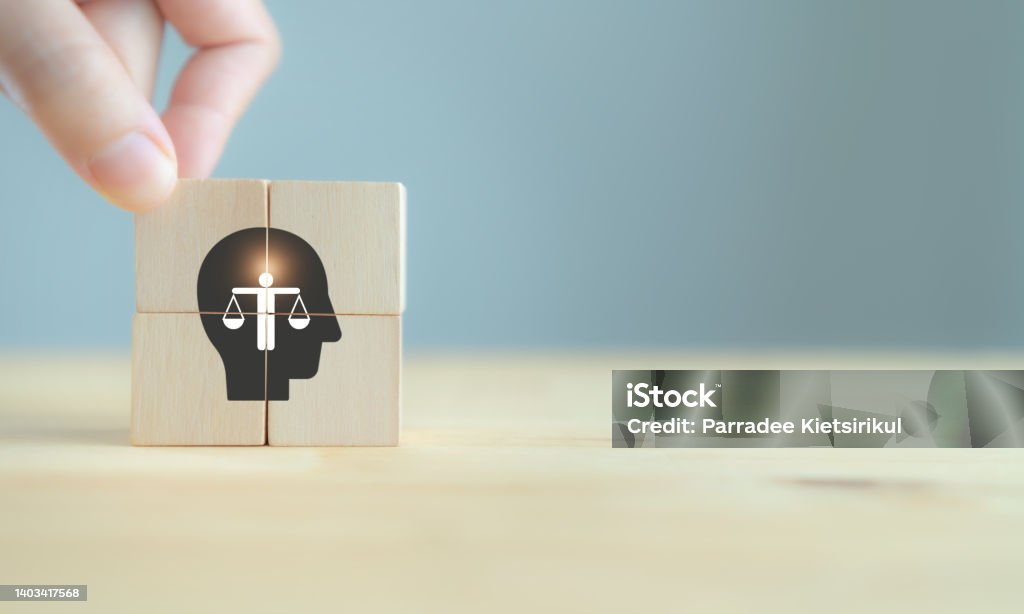 Business ethics concept. Ethics inside human mind. Business integrity and moral. The wooden cubes with ethics inside a head symbols on grey background and copy space. Company ethics culture. ESG. Morality Stock Photo