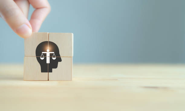 Business ethics concept. Ethics inside human mind. Business integrity and moral. The wooden cubes with ethics inside a head symbols on grey background and copy space. Company ethics culture. ESG. Business ethics concept. Ethics inside human mind. Business integrity and moral. The wooden cubes with ethics inside a head symbols on grey background and copy space. Company ethics culture. ESG. morality stock pictures, royalty-free photos & images