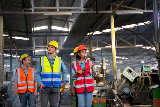 istock Blue collar worker with co worker at factory. 1403418267