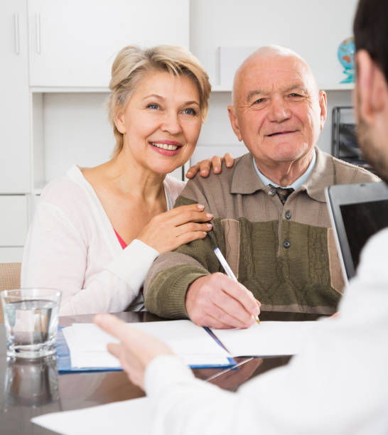 istock couple signing papers in bank 1403418288
