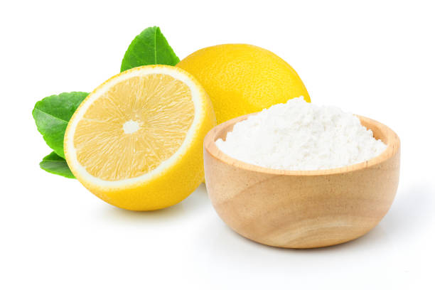 Baking soda or sodium bicarbonate powder and fresh lemon fruit stock photo