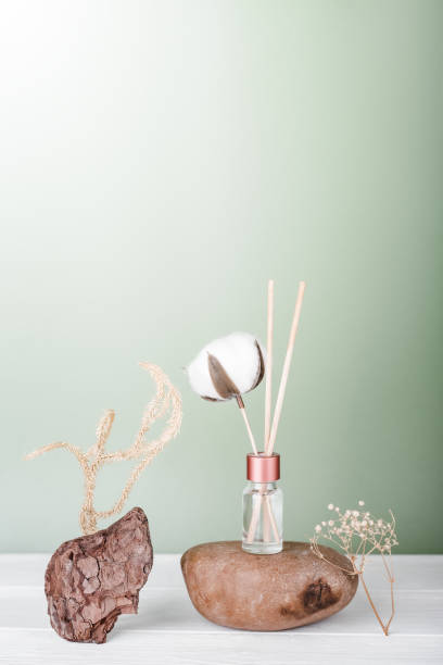 istock hygge and aromatherapy concept. aroma reed diffuser, cotton bud on white table at home. minimal style composition. winter and autumn mood. 1403421125