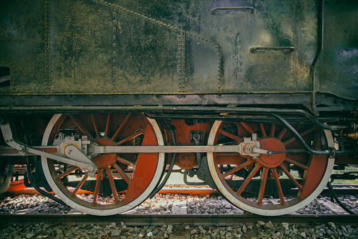 large metal wheels of an old train at a railway transport exhibition