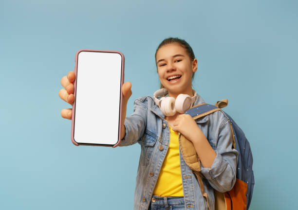 istock kid showing screen of mobile phone 1403422487